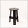 Vintage black-stained wooden tripod stool with mortise joints.