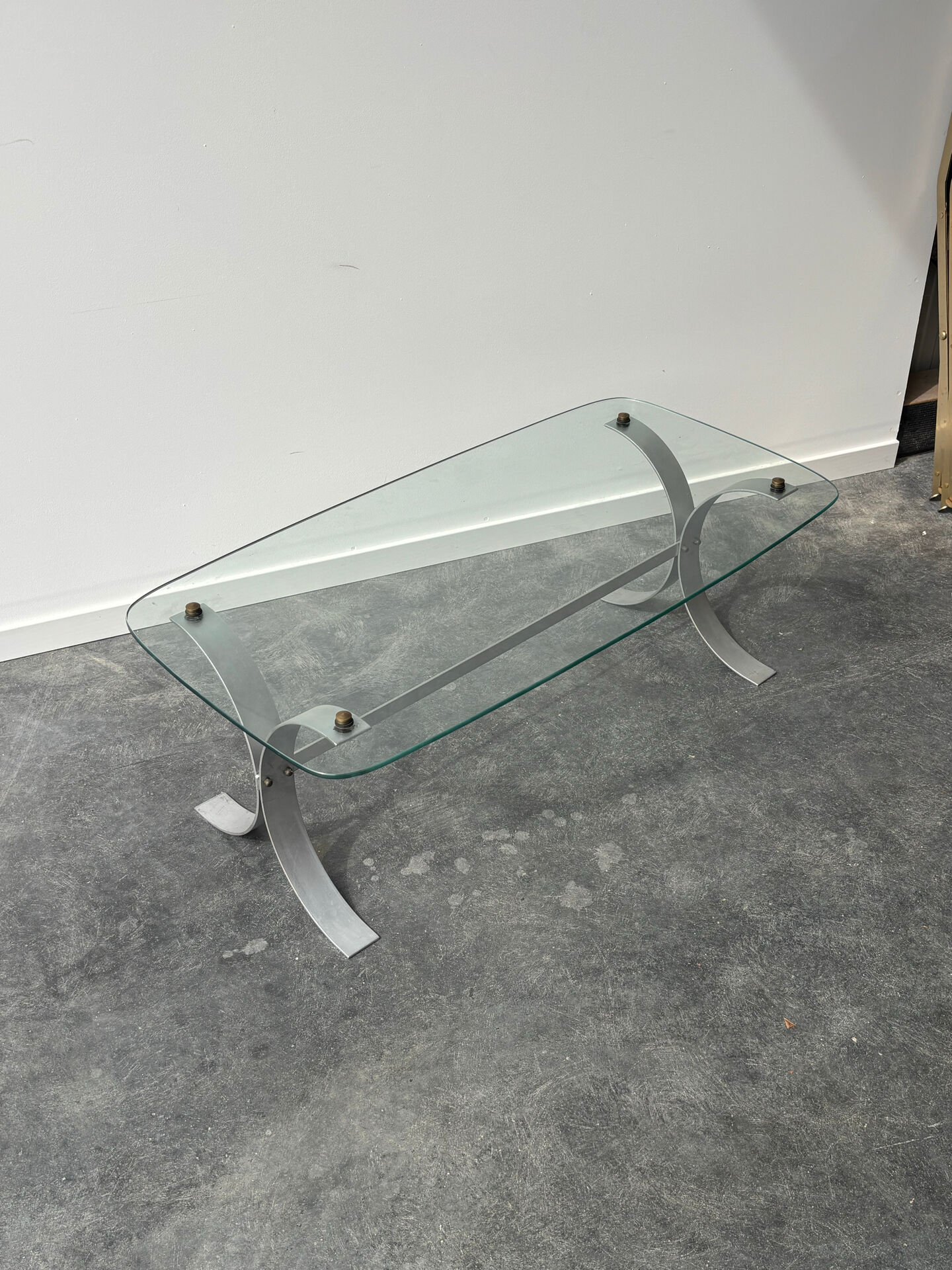 Design coffee table in brushed metal with a glass top, 1970s.