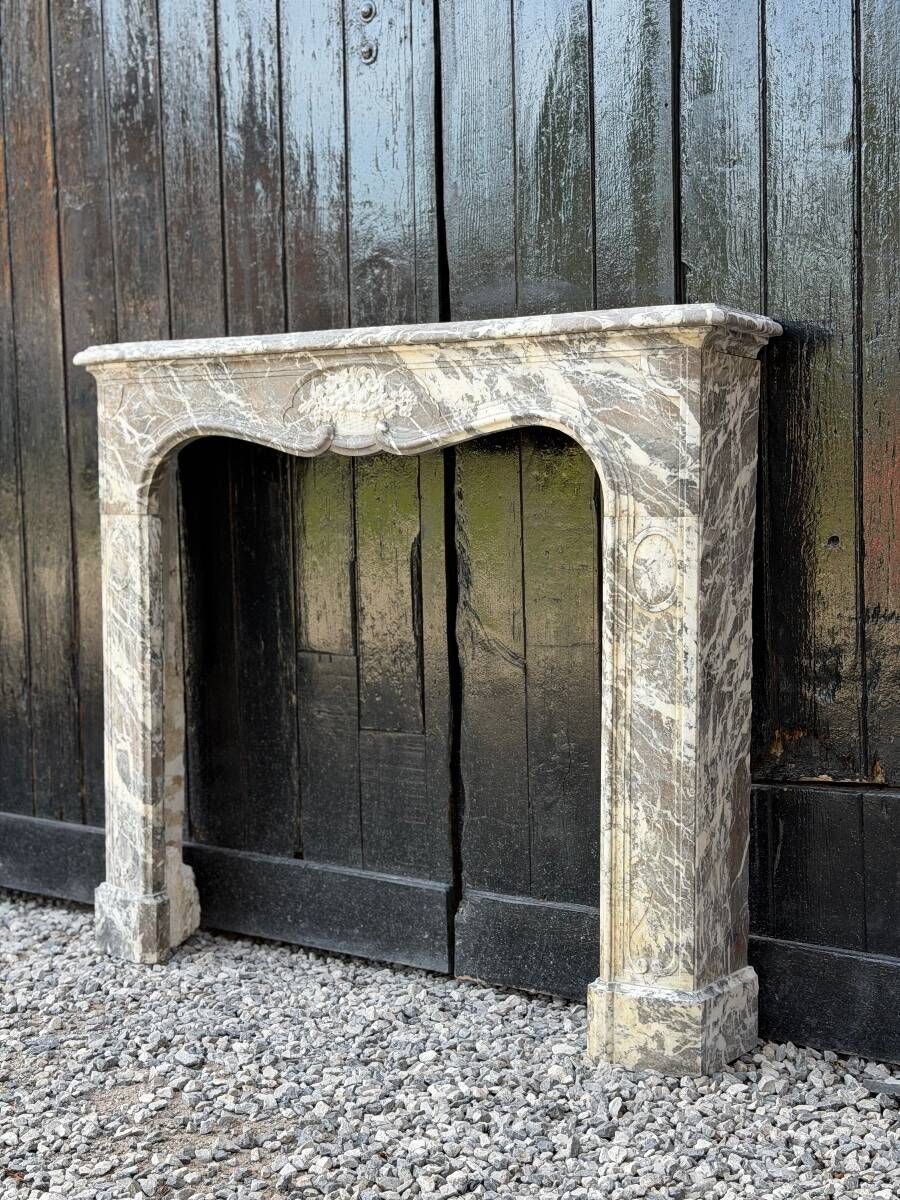 Louis XV fireplace in grey Ardennes marble, a floral basket in white marble, late 18th century.