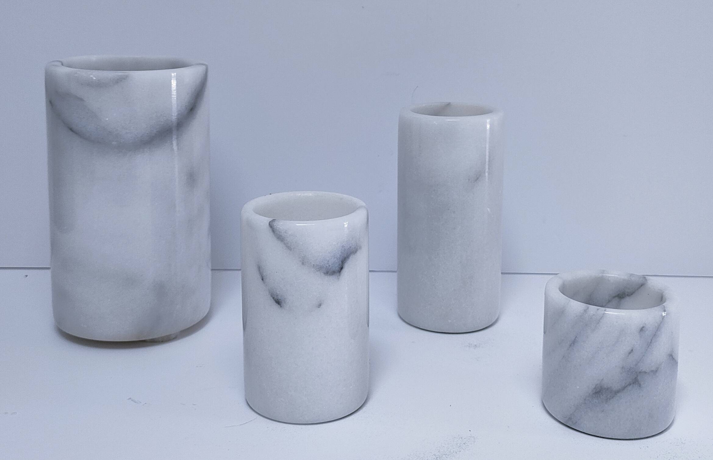 Four white marble candlesticks with black veins, 70s design