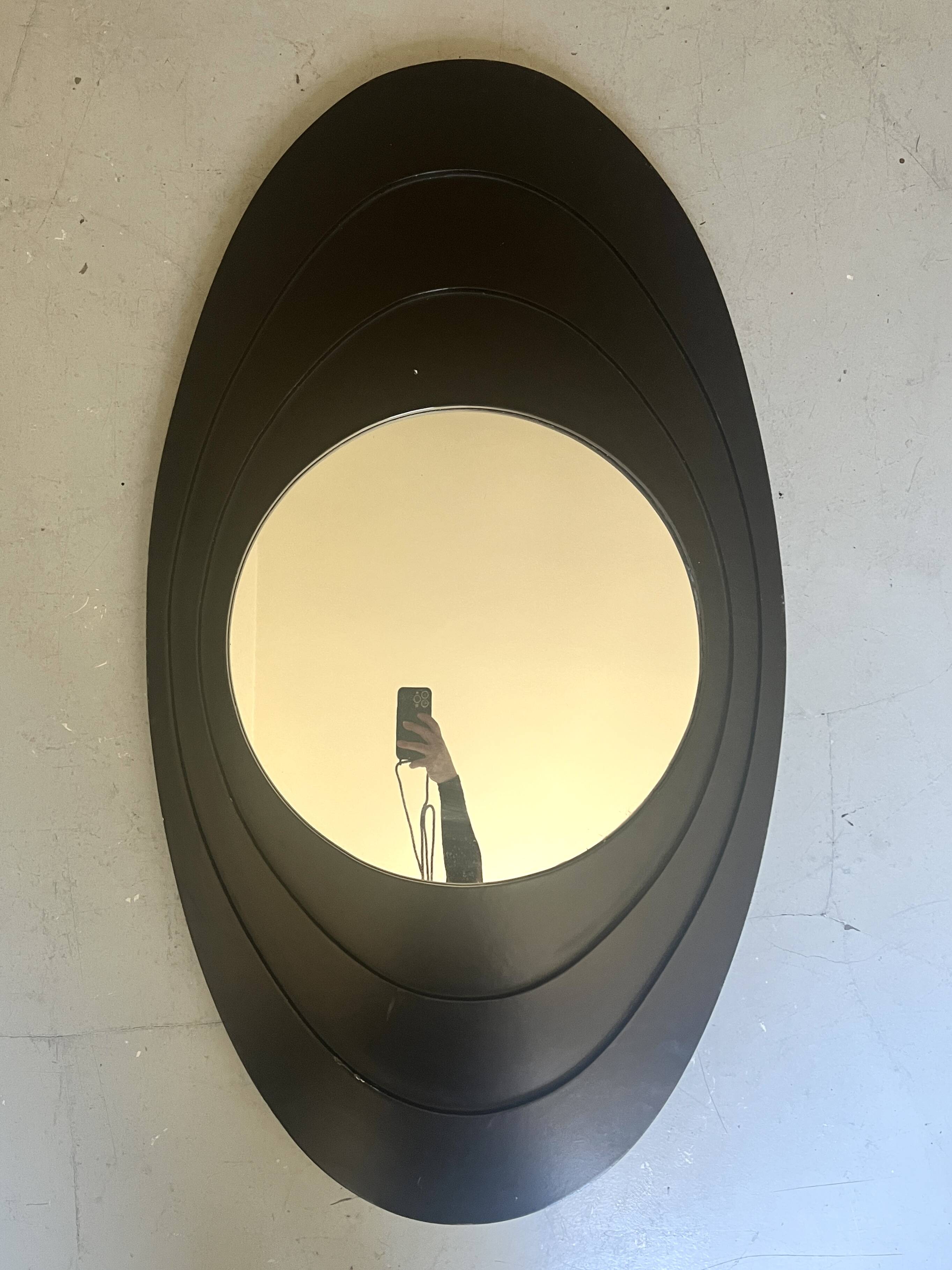 Large oval Italian mirror, modernist, space age design from the 1970s.