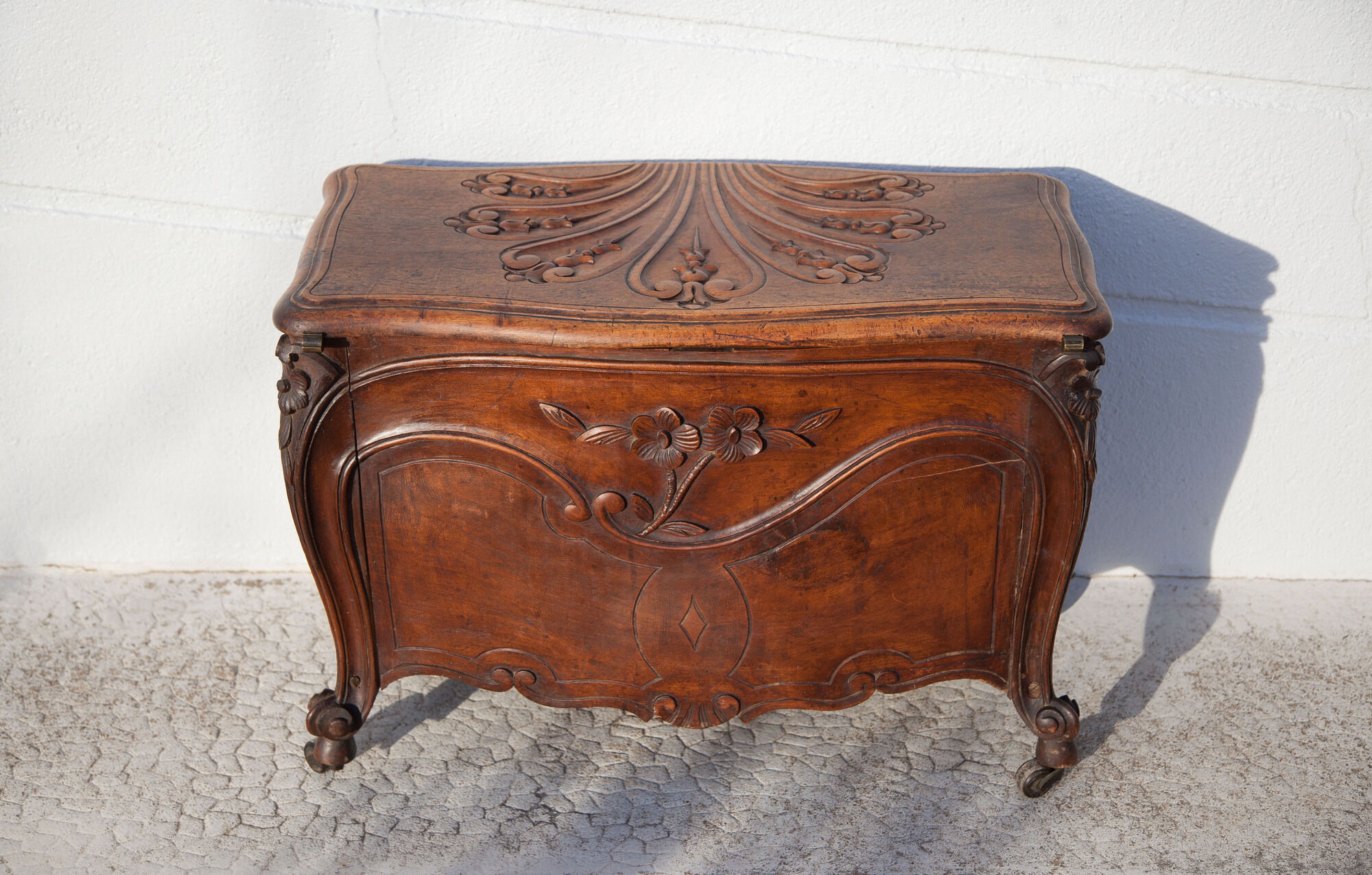 Old chest, carved wooden chest, curved chest on wheels, interior decoration