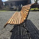 Wooden garden bench with cast iron base