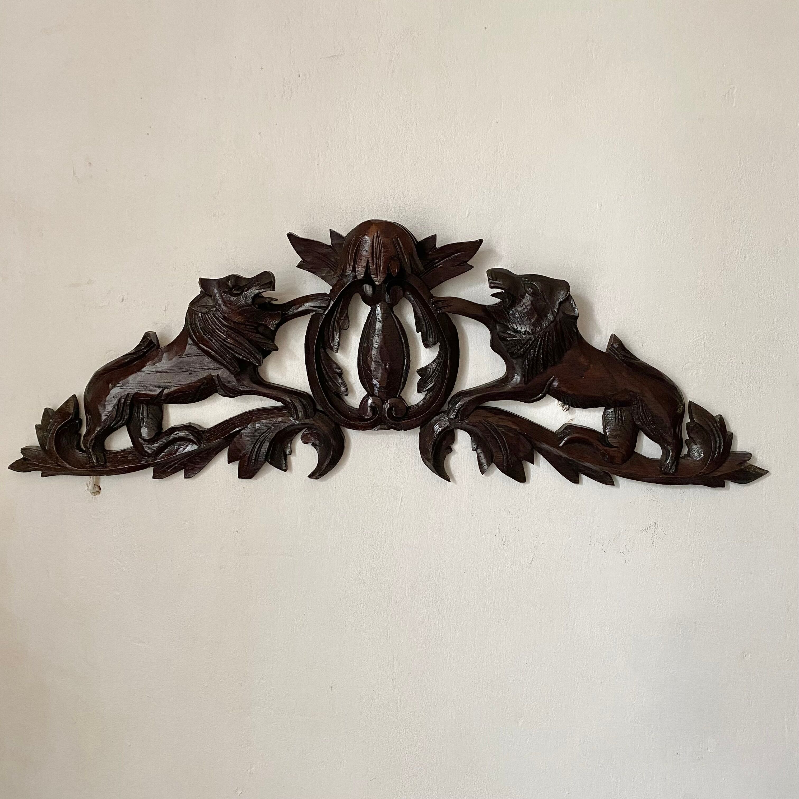 Antique carved wooden pediment with lions and medallion