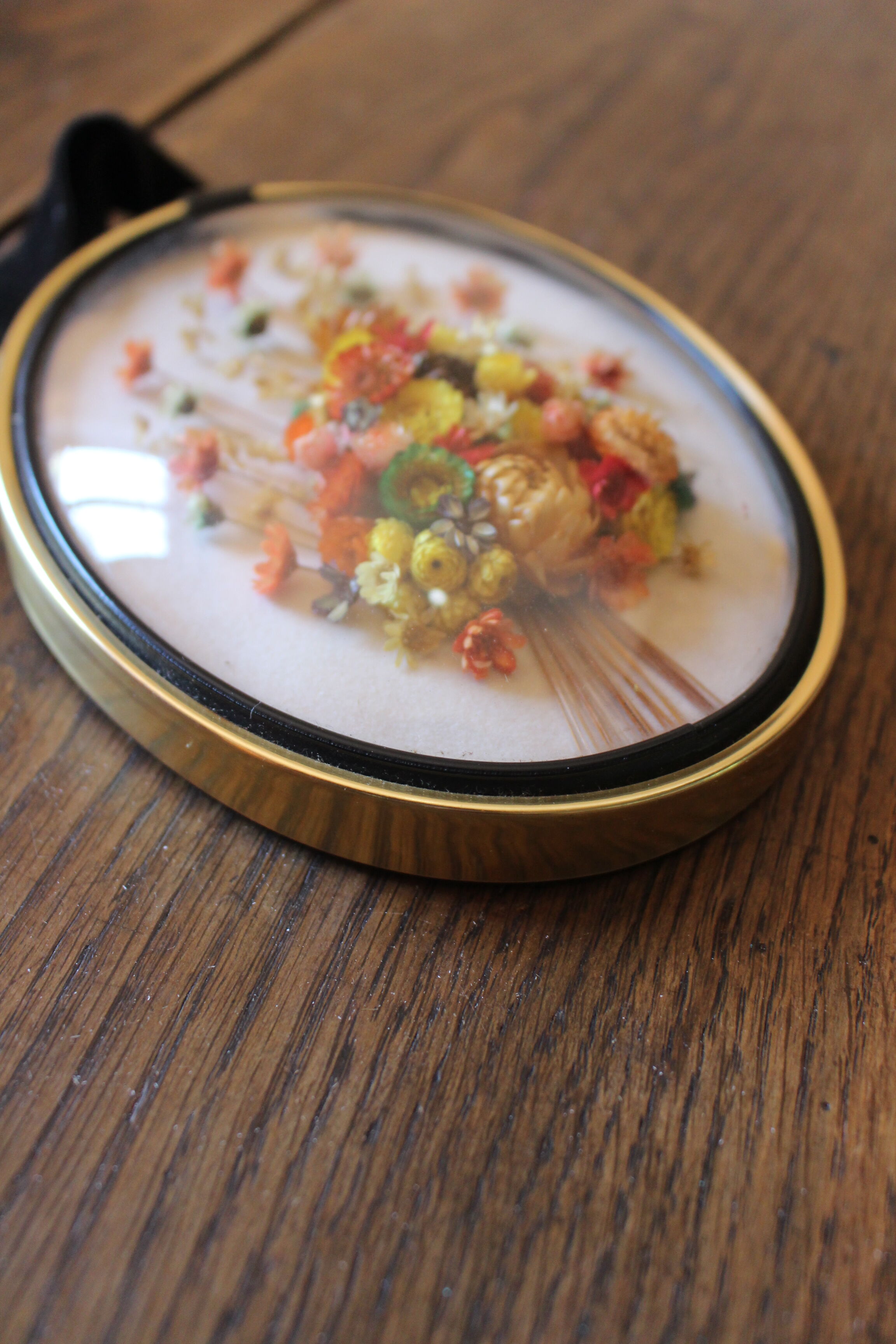 Vintage medallion domed glass dried flowers black gold