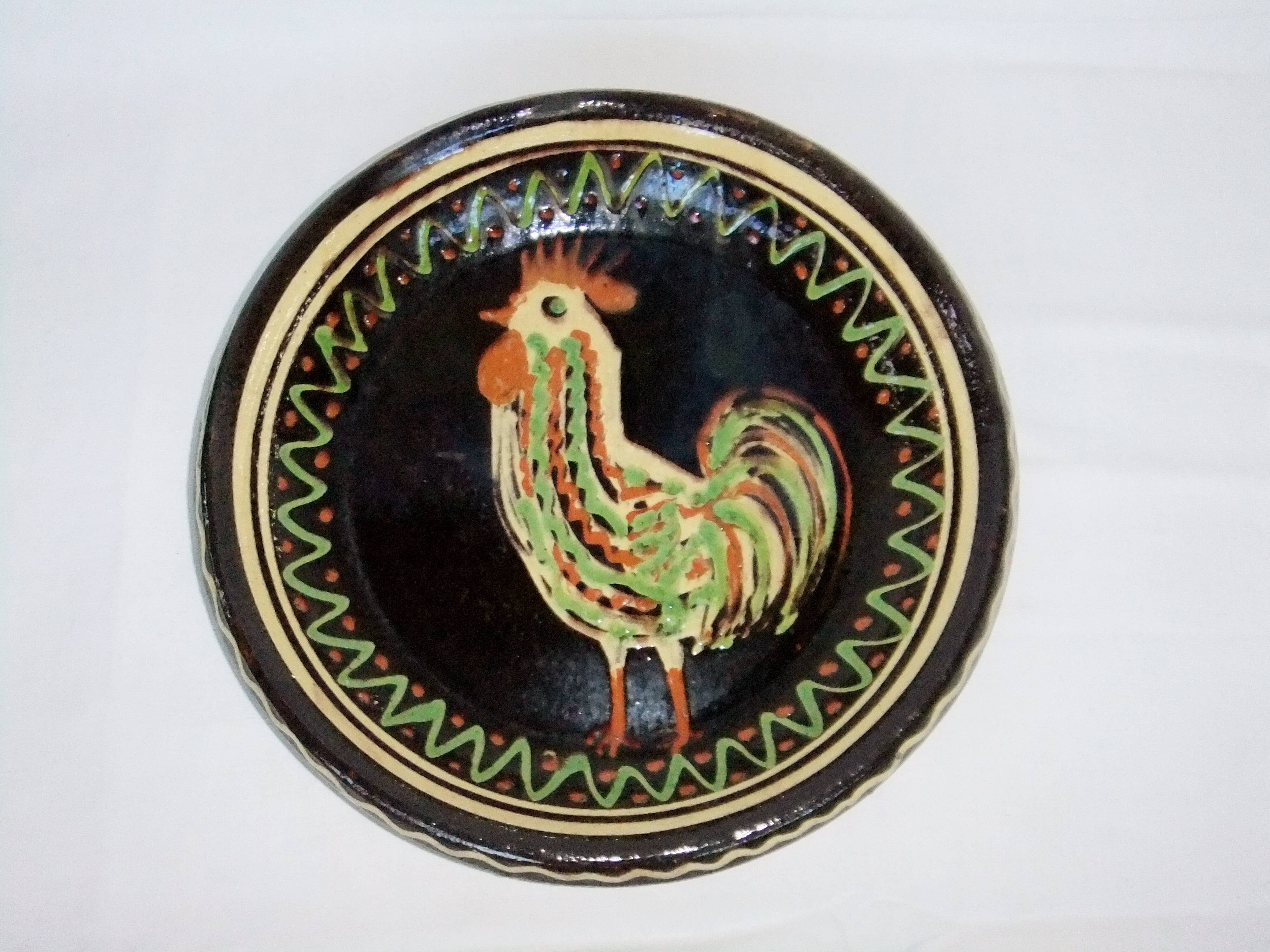 old terracotta dish decorated with rooster