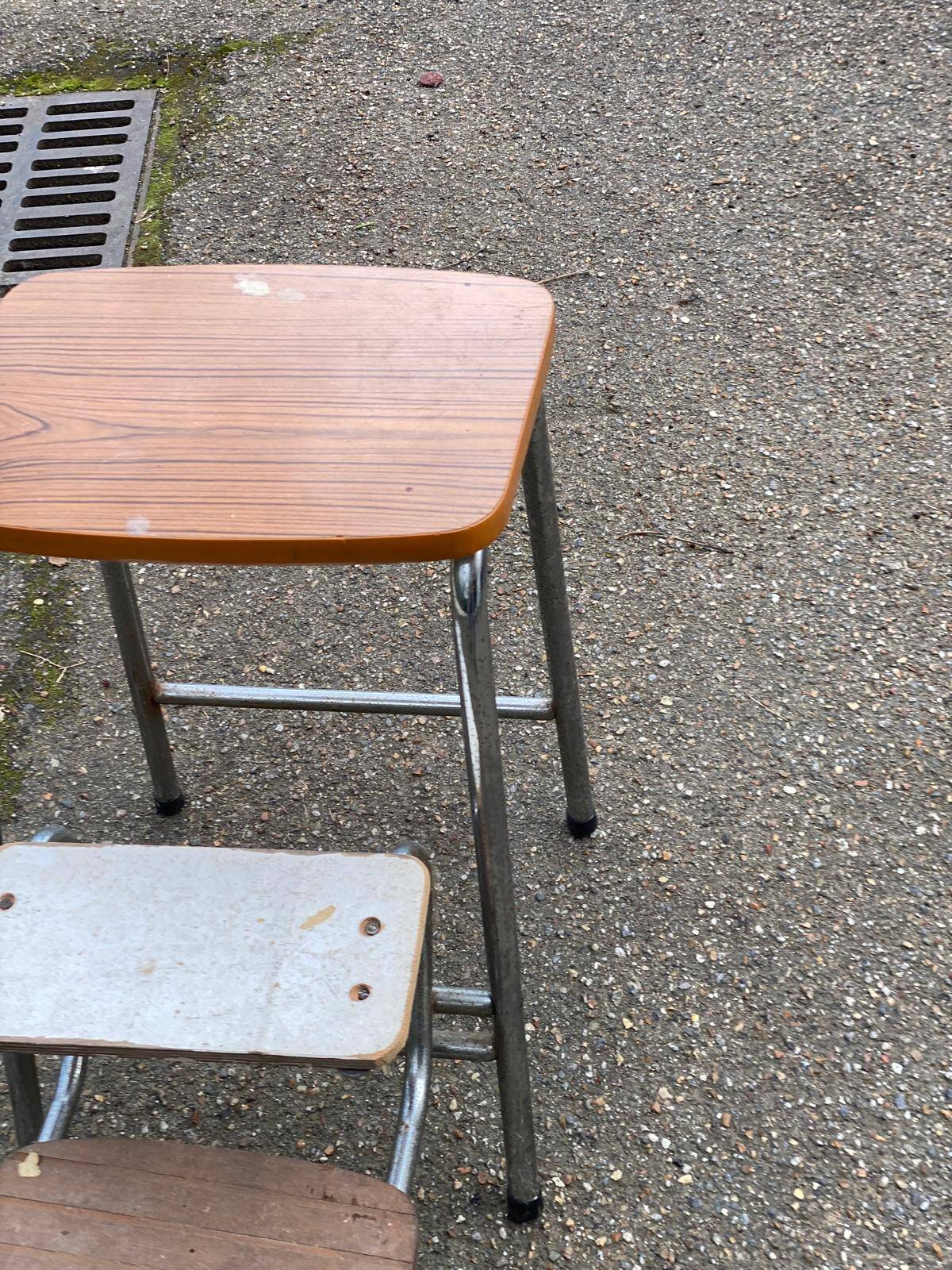 Folding stool in formica with a wood effect.