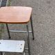 Folding stool in formica with a wood effect.