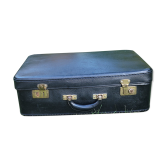 Black suitcase in vintage cardboard