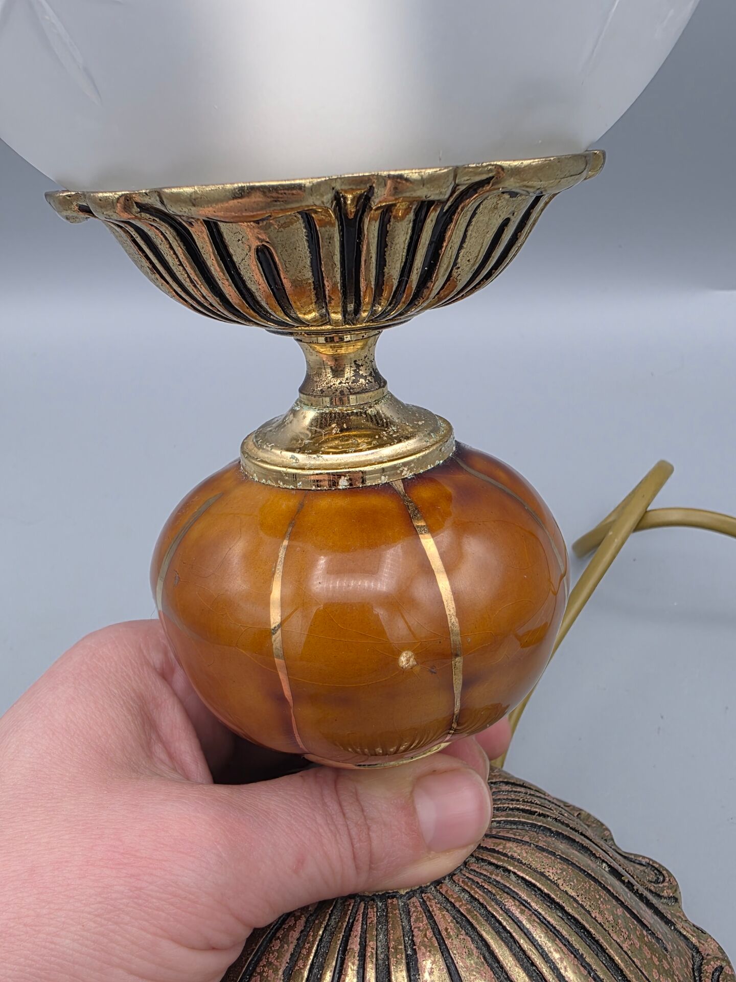 Hollywood Regency bedside lamp in gold metal with a glass globe.