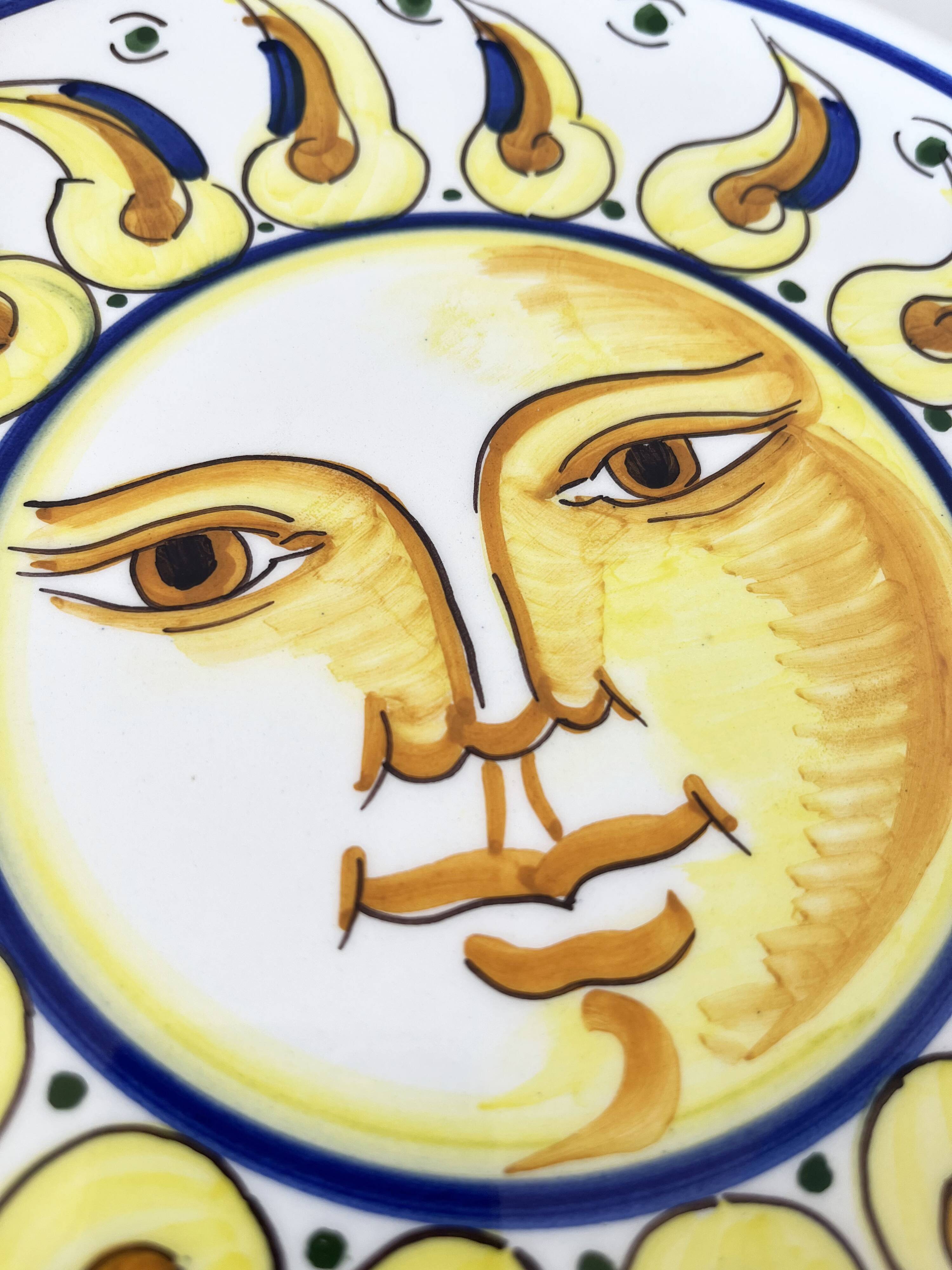 Decorative ceramic plate with sun face