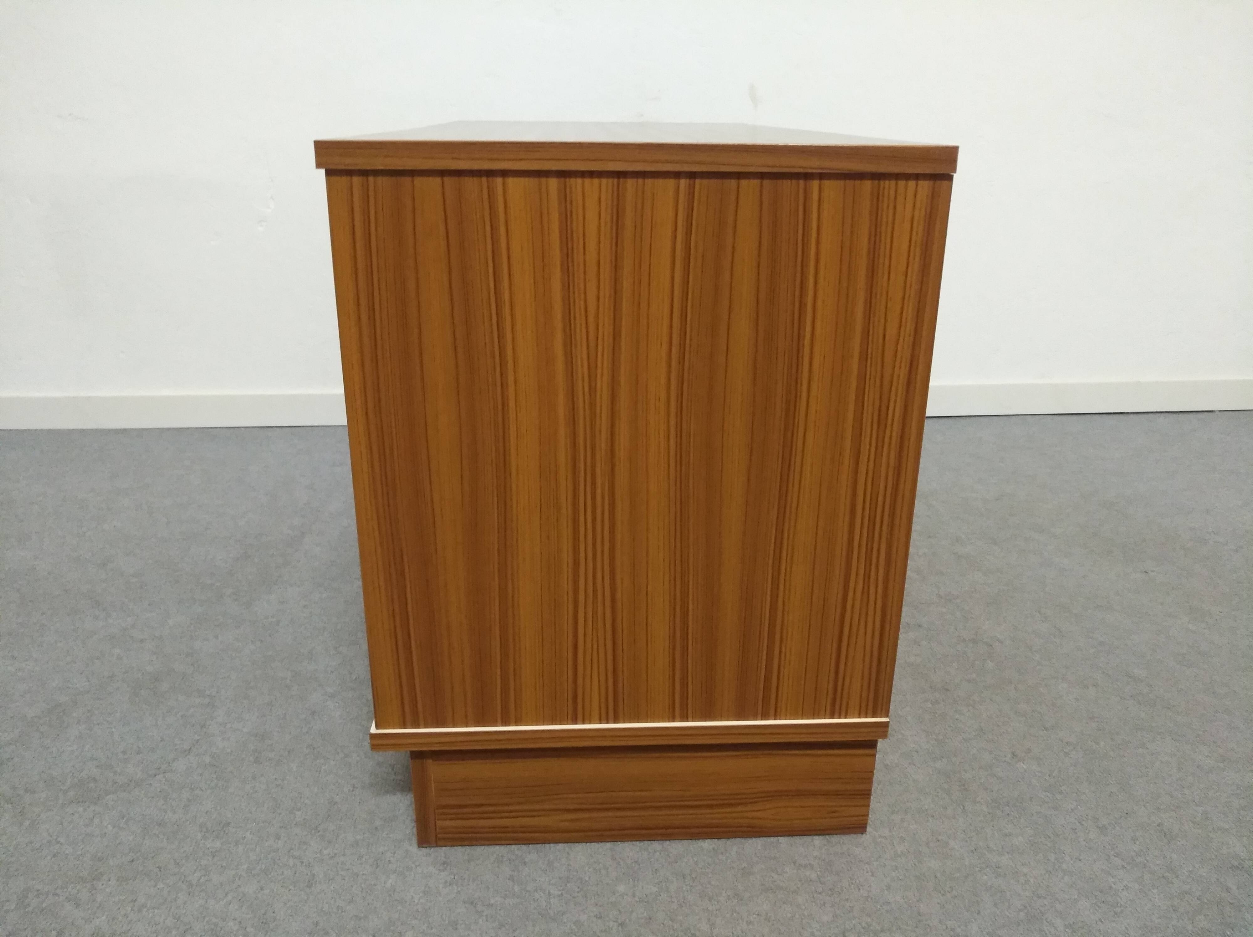 Low chest of drawers with 3 drawers in mahogany and white satin, France circa 1980.