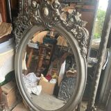 Beveled oval mirror in wood and stucco