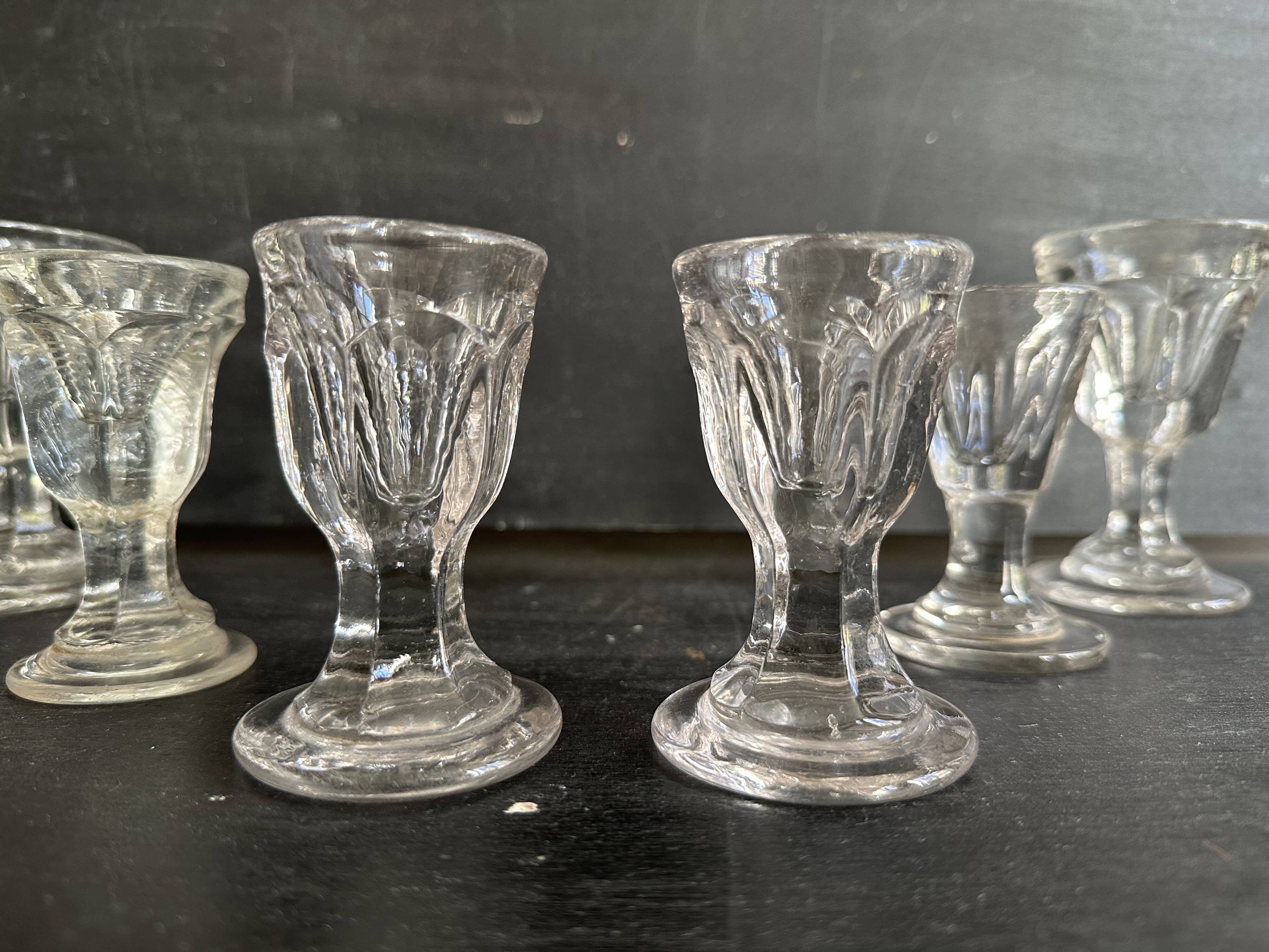 Set of antique liqueur glasses in thick glass, bistro style.