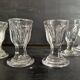Set of antique liqueur glasses in thick glass, bistro style.