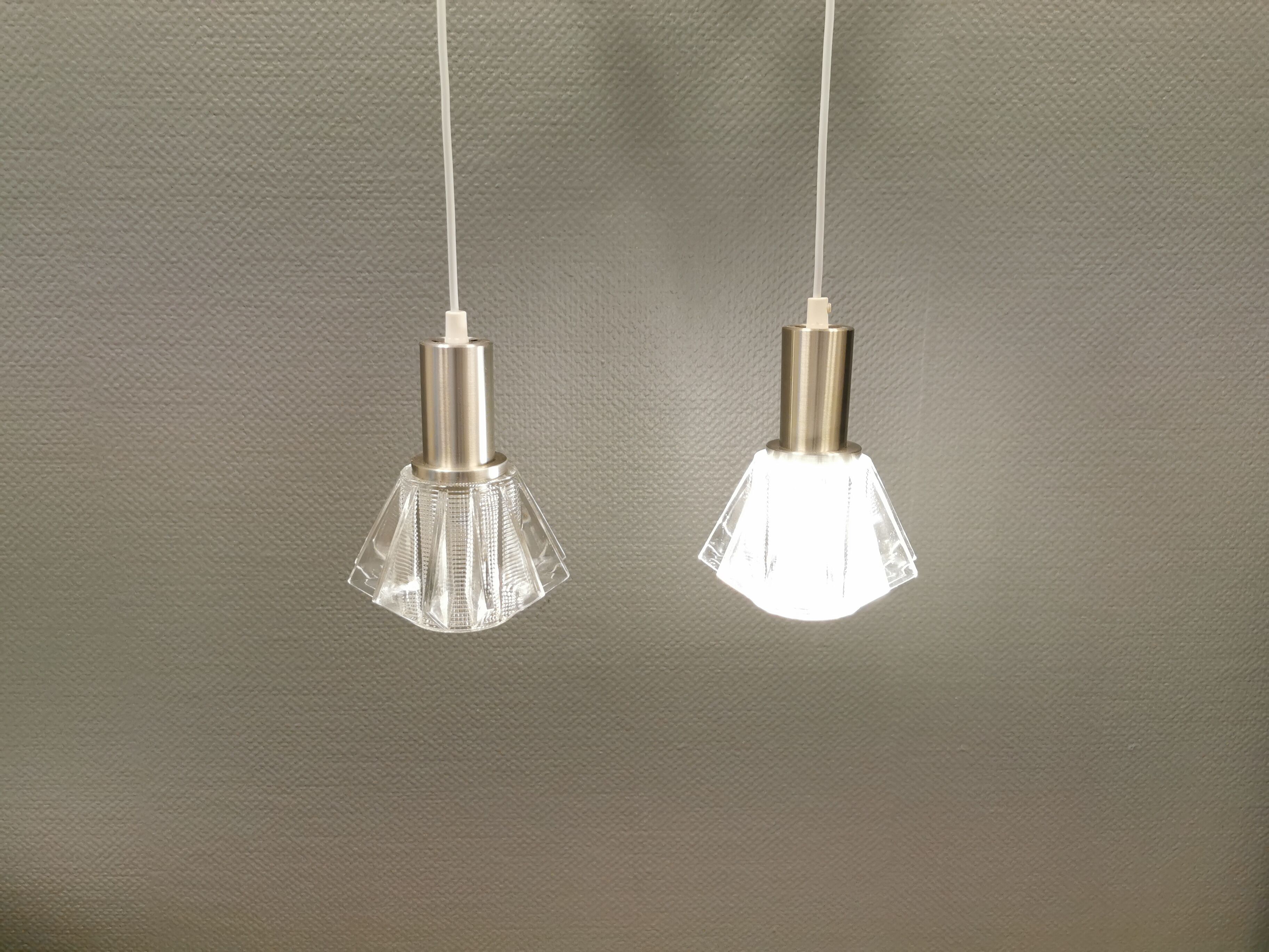 A set of smaller hanging lamps, in hard pressed glass, with metal top