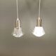 A set of smaller hanging lamps, in hard pressed glass, with metal top