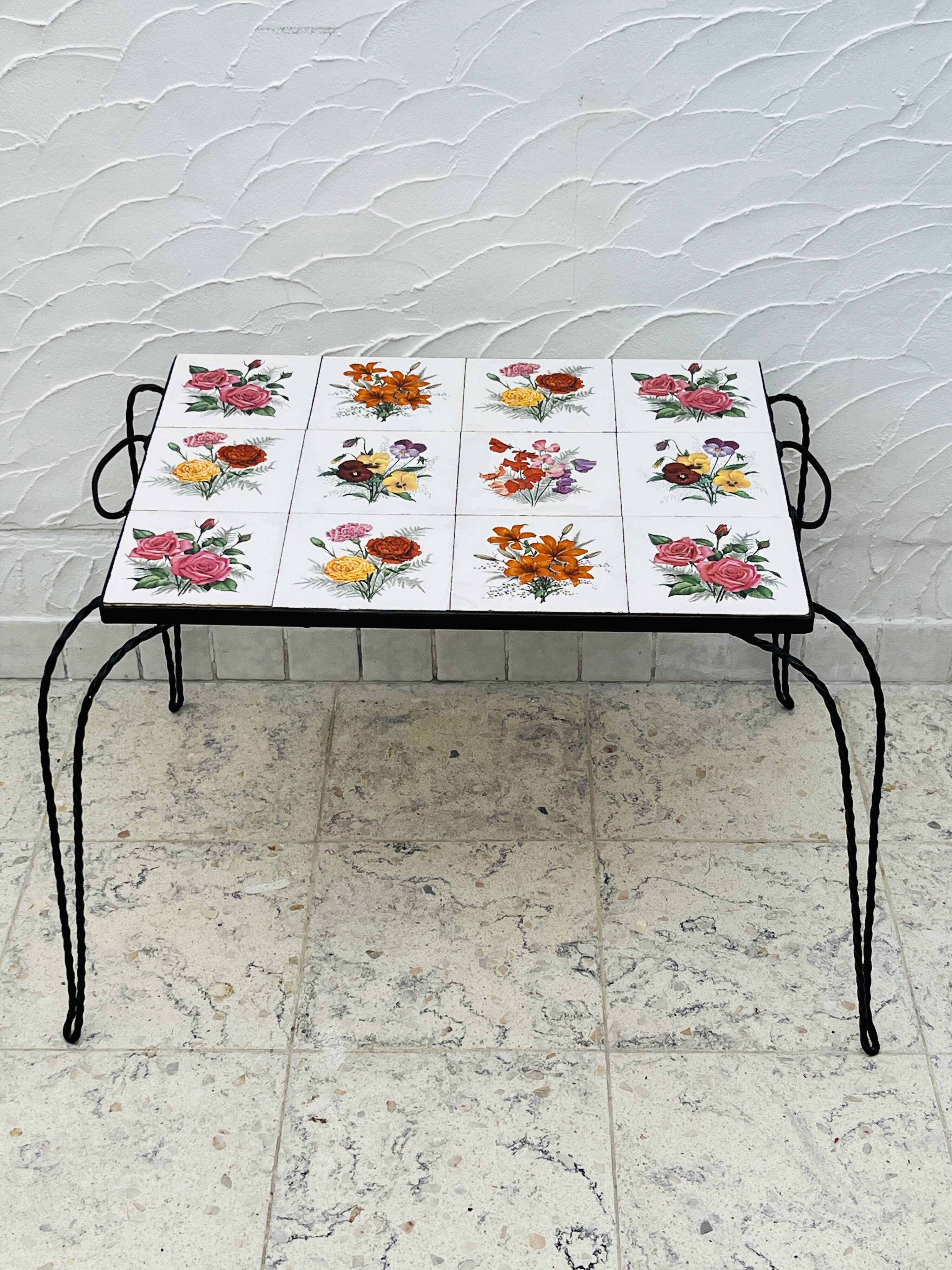 Vintage coffee table in wrought iron with floral tiles.