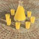 Liqueur service composed of a glass carafe and 8 small yellow screen-printed glasses