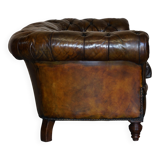 Victorian Chesterfield leather upholstered canapé with feather cushions.