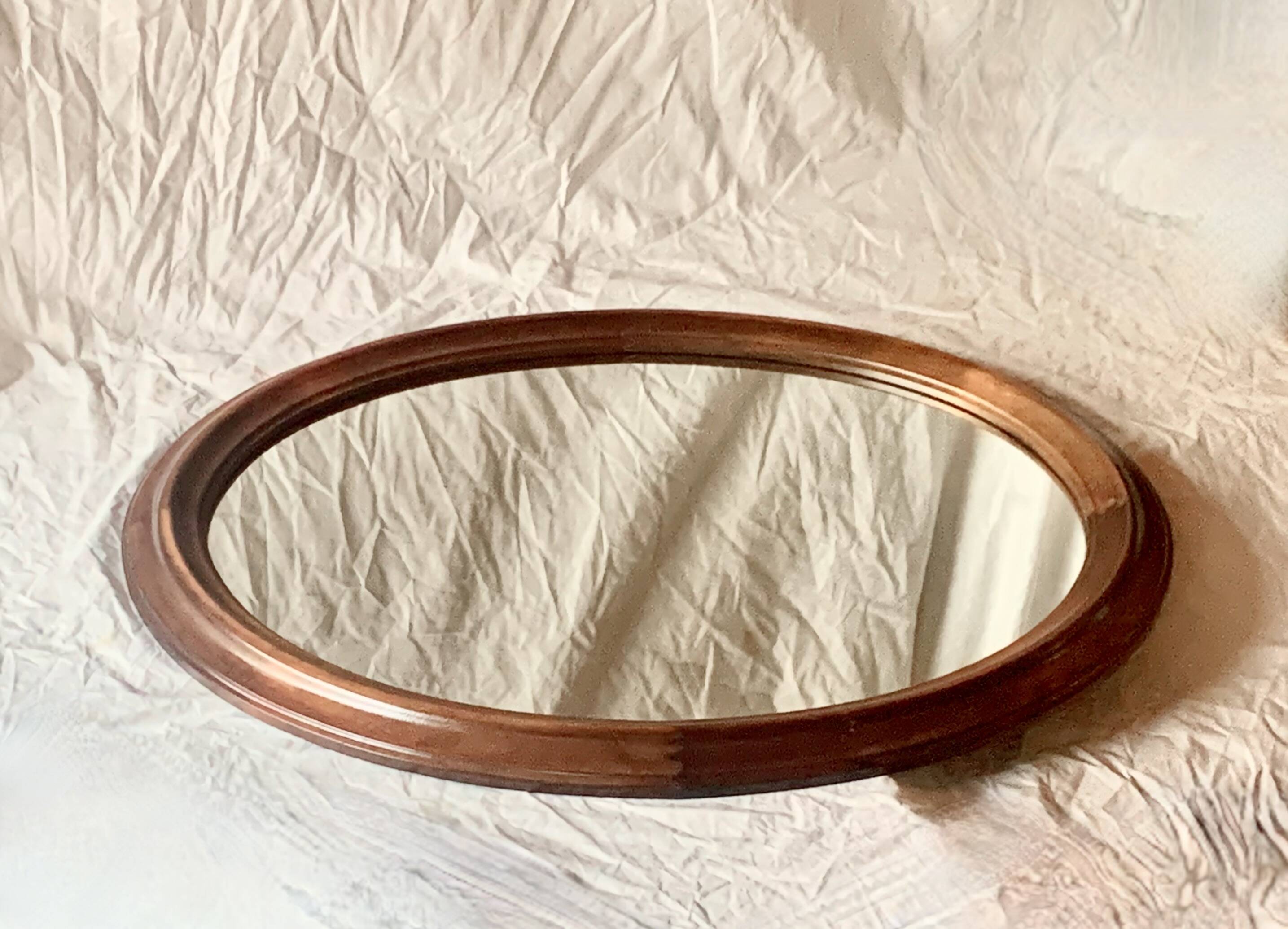 Old large oval wooden wall mirror