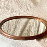 Old large oval wooden wall mirror