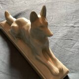 Vintage ceramic lying dog on base