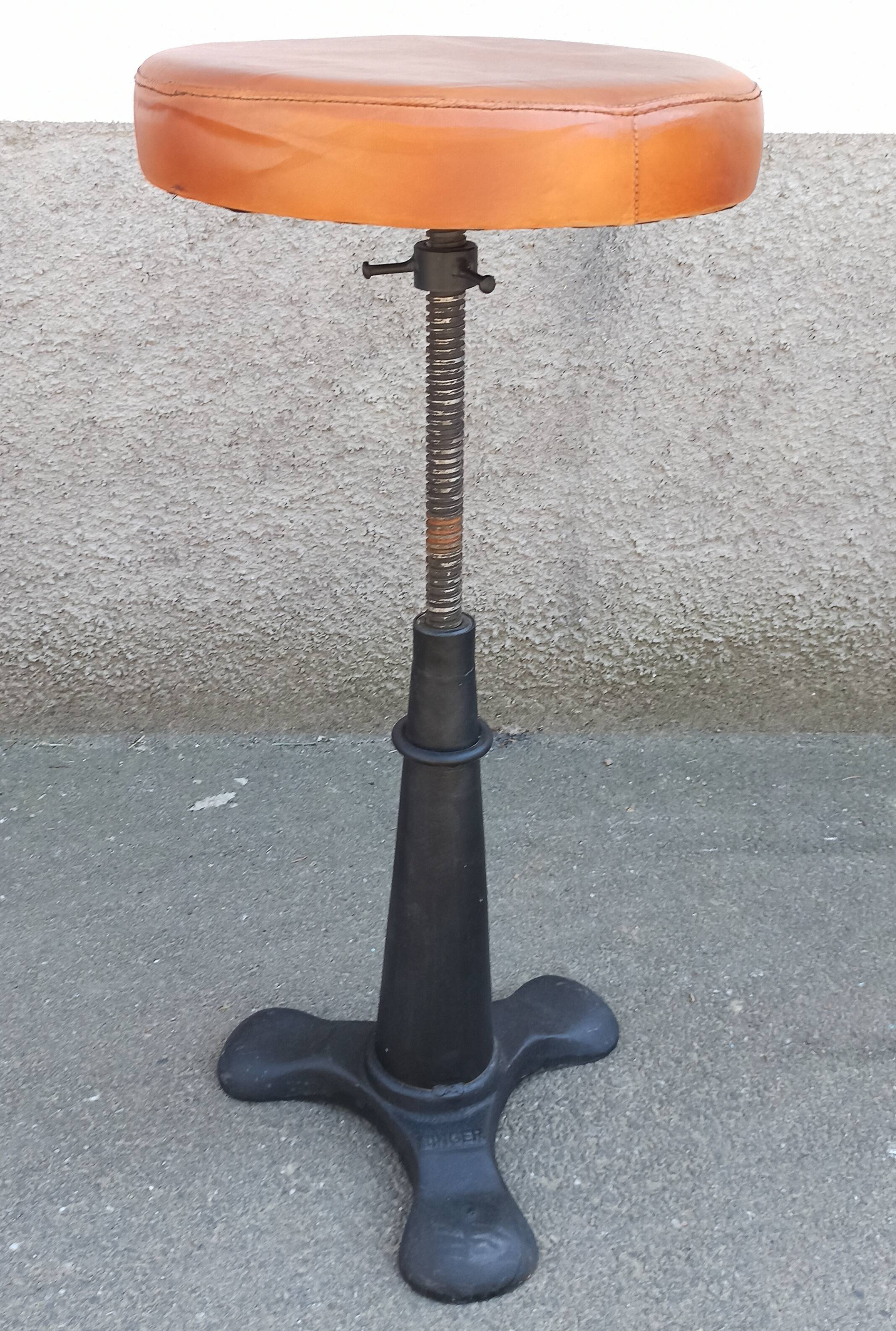 Height-adjustable leather stool with cast iron base