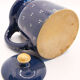 Pitcher and navy blue lid with off-white peas