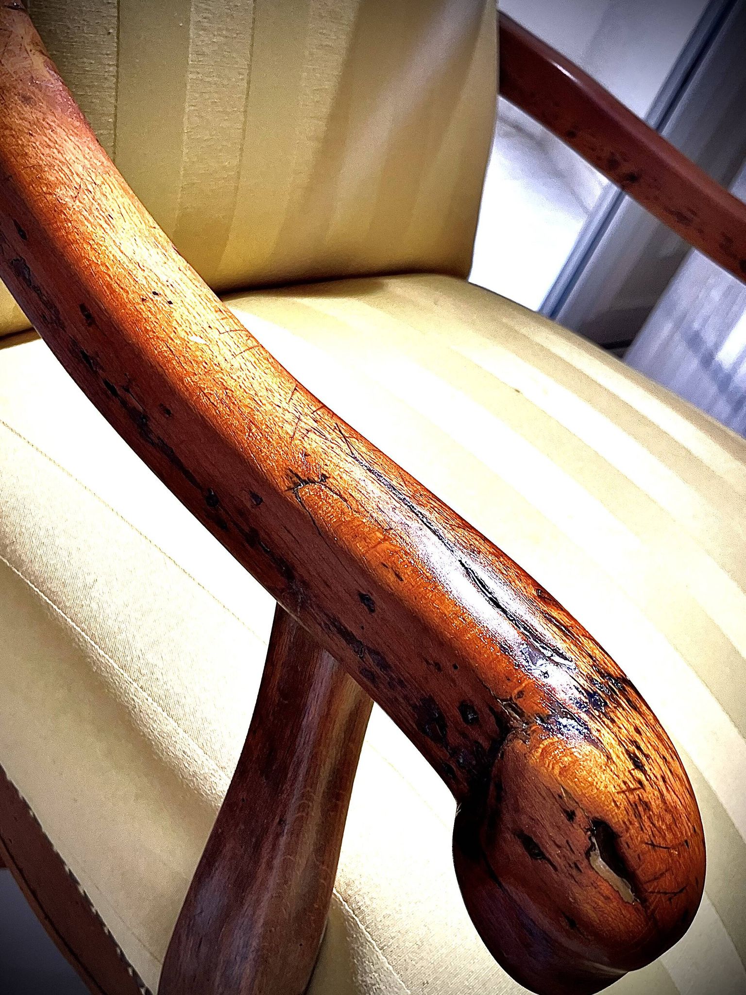 Wingback armchair in walnut in the French Regency style with stretcher in