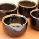 Set of 8 black ceramic cups signed