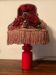 Scandinavian wooden lamp with fringed shade.