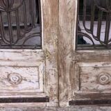 Chiseled teak door with openwork wrought iron panels