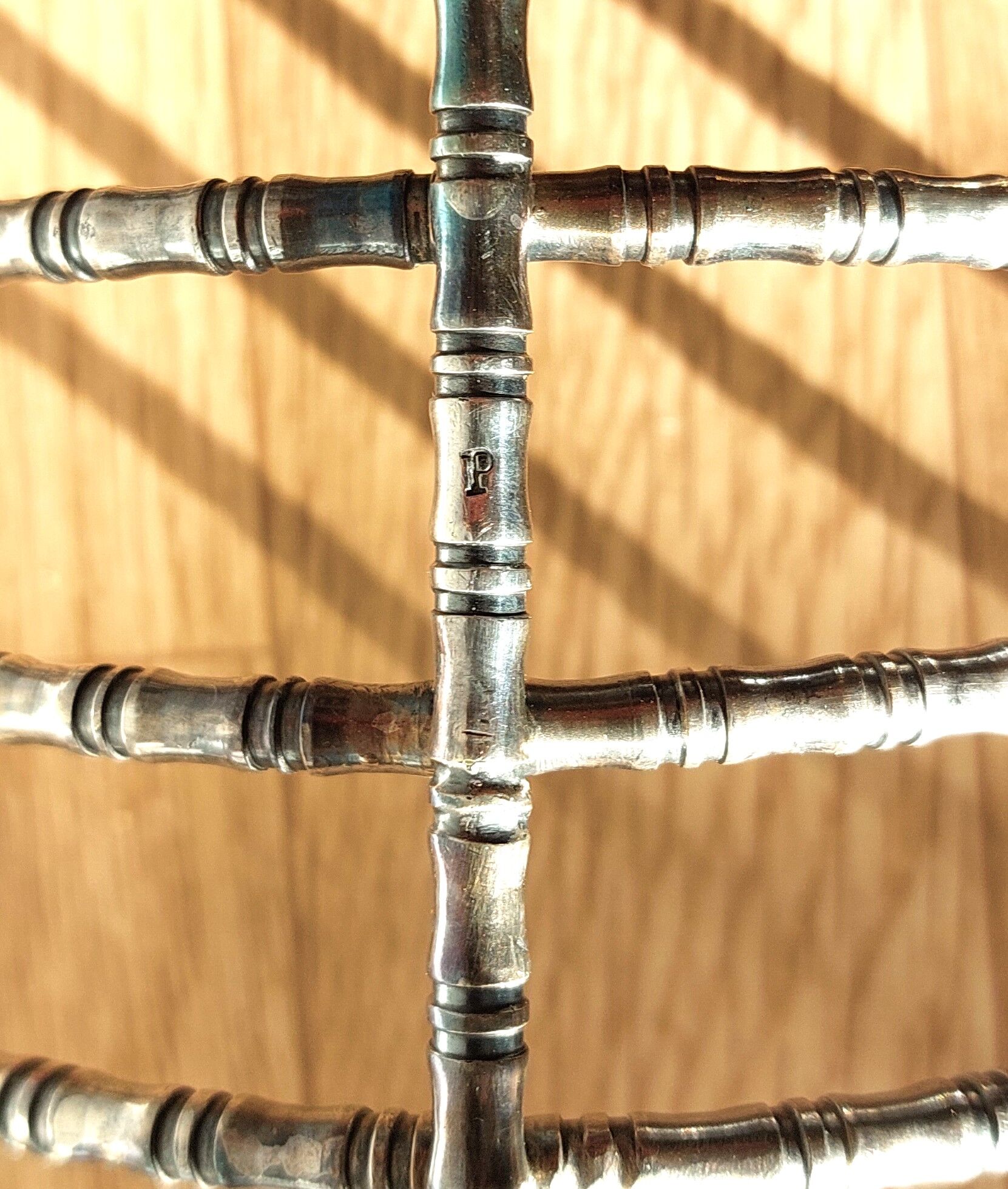 Silver metal cut in imitation of vintage bamboo.
