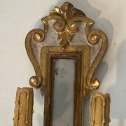 Pair of wall sconces in carved wood and silvered and gilded patinated metal with a central mirror.
