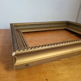 Frame with channels in wood and gilded stucco