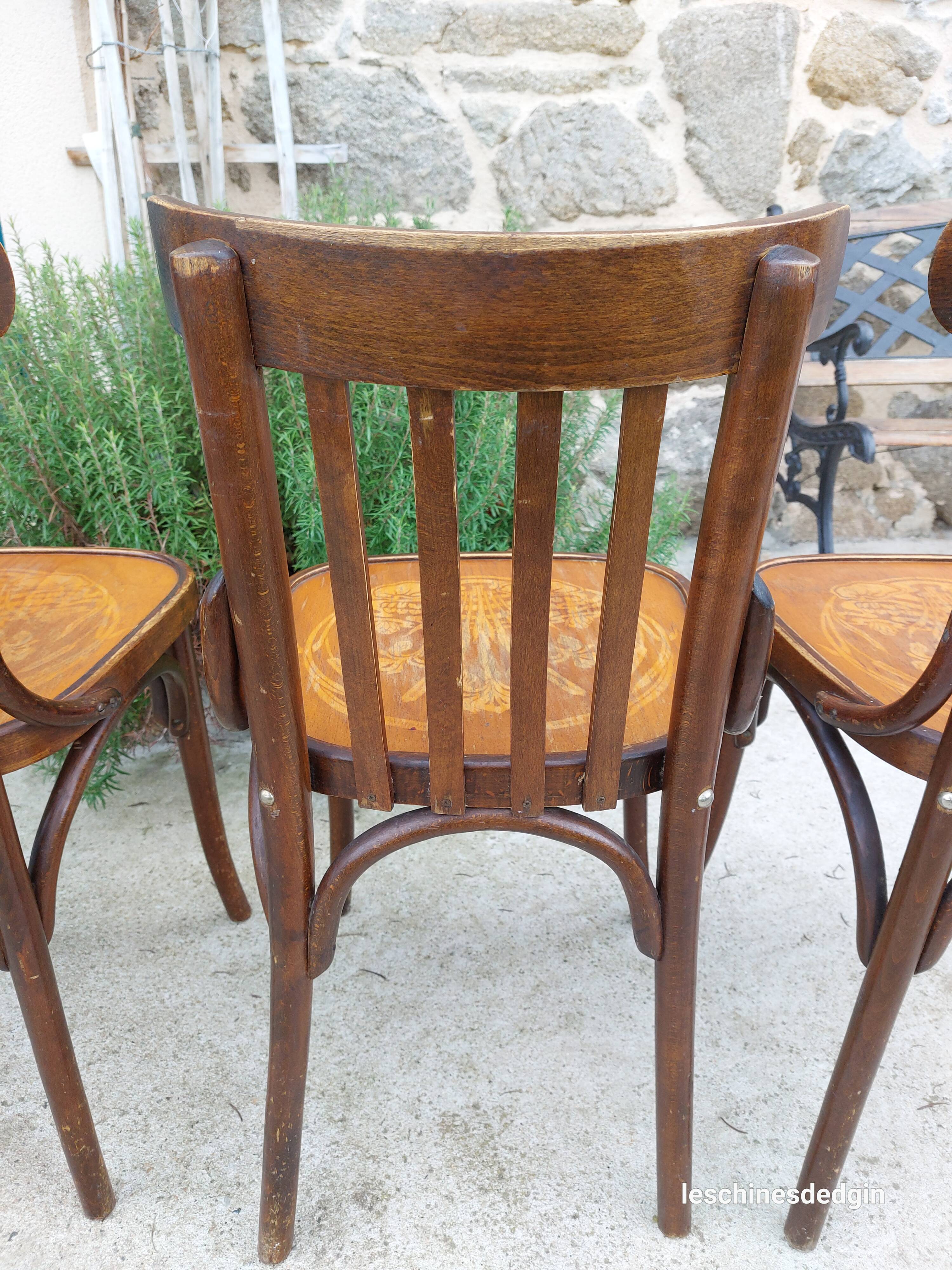4 bentwood bistro chairs with a pattern on the seat