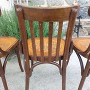 4 bentwood bistro chairs with a pattern on the seat