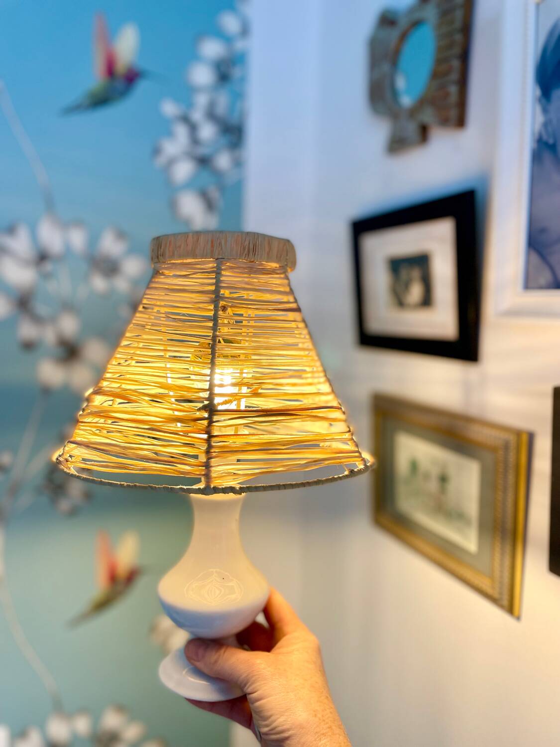 White porcelain table lamp and vintage raffia lampshade