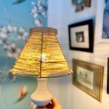White porcelain table lamp and vintage raffia lampshade