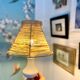 White porcelain table lamp and vintage raffia lampshade