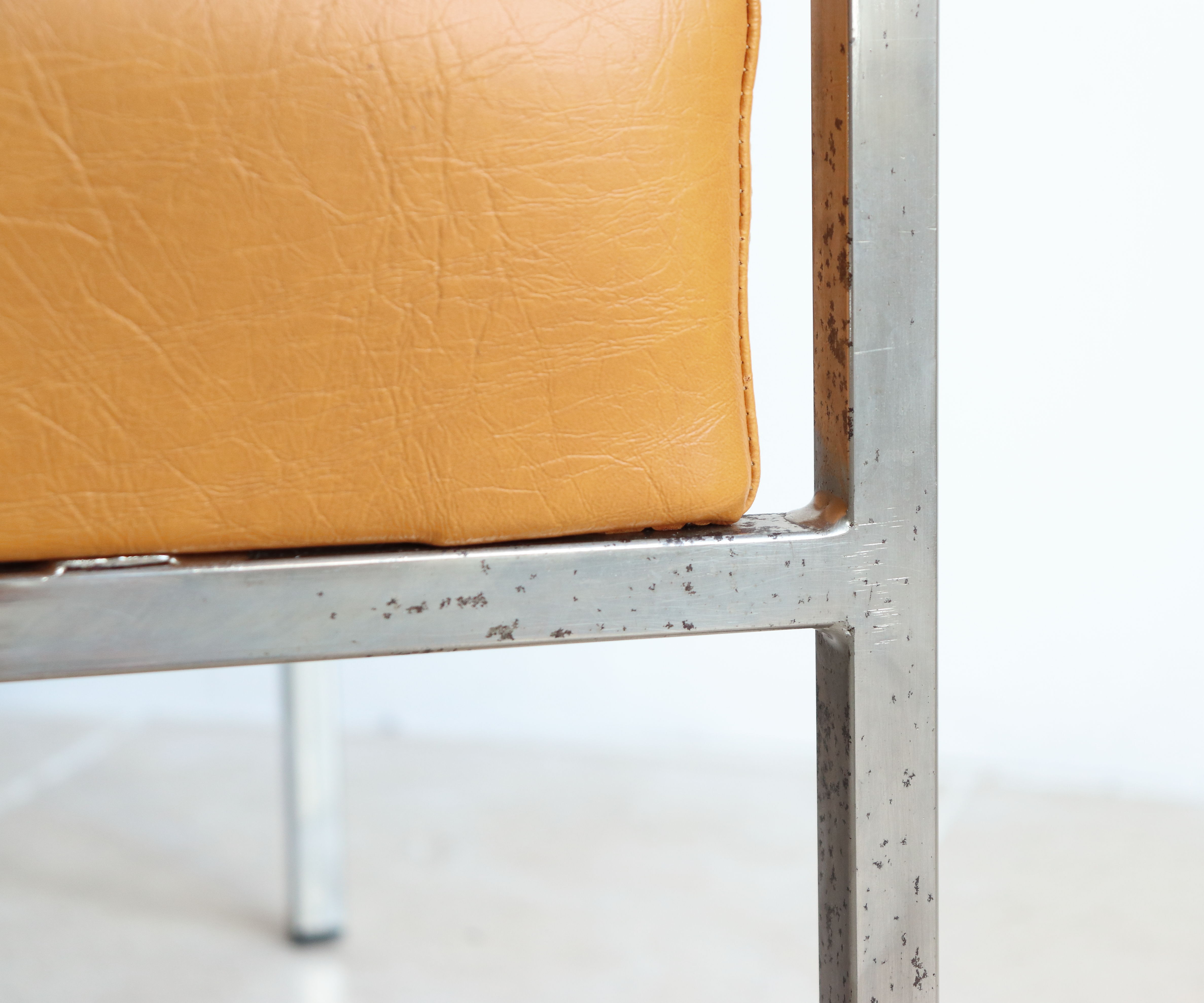 Modernist armchair in chromed metal and imitation leather, 50s/60s