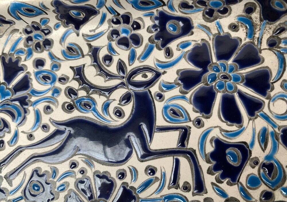 Vintage handmade blue ceramic ashtray with deer and flower ornament from Rodos Ceramics.