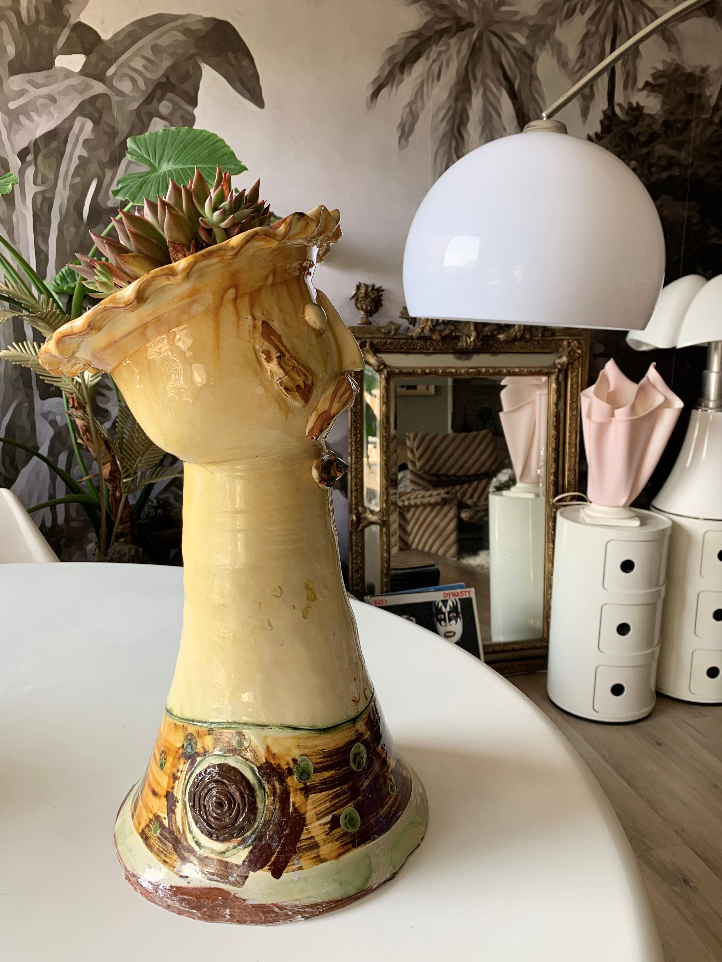Terracotta plant holder head shape