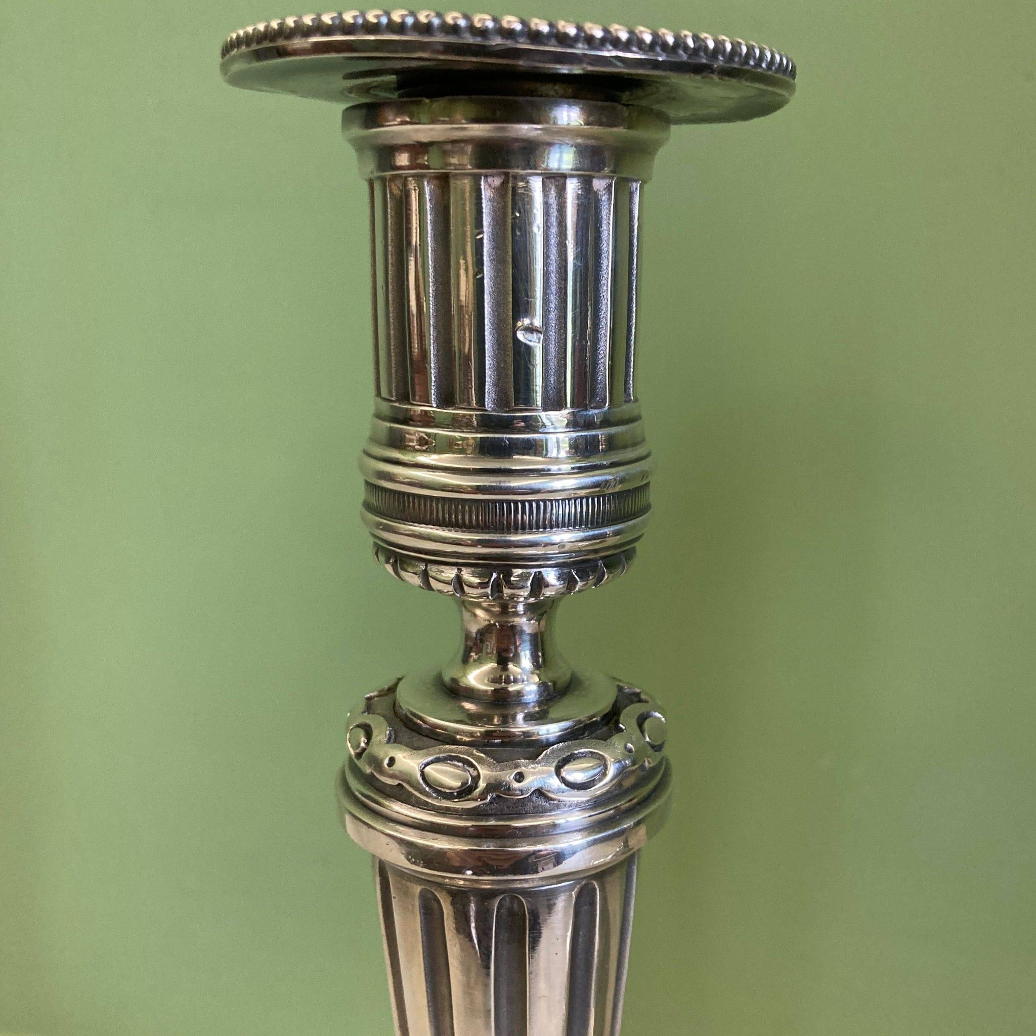 Pair of silvered bronze candlesticks in the Louis XVI style signed Voisenet, 19th century.