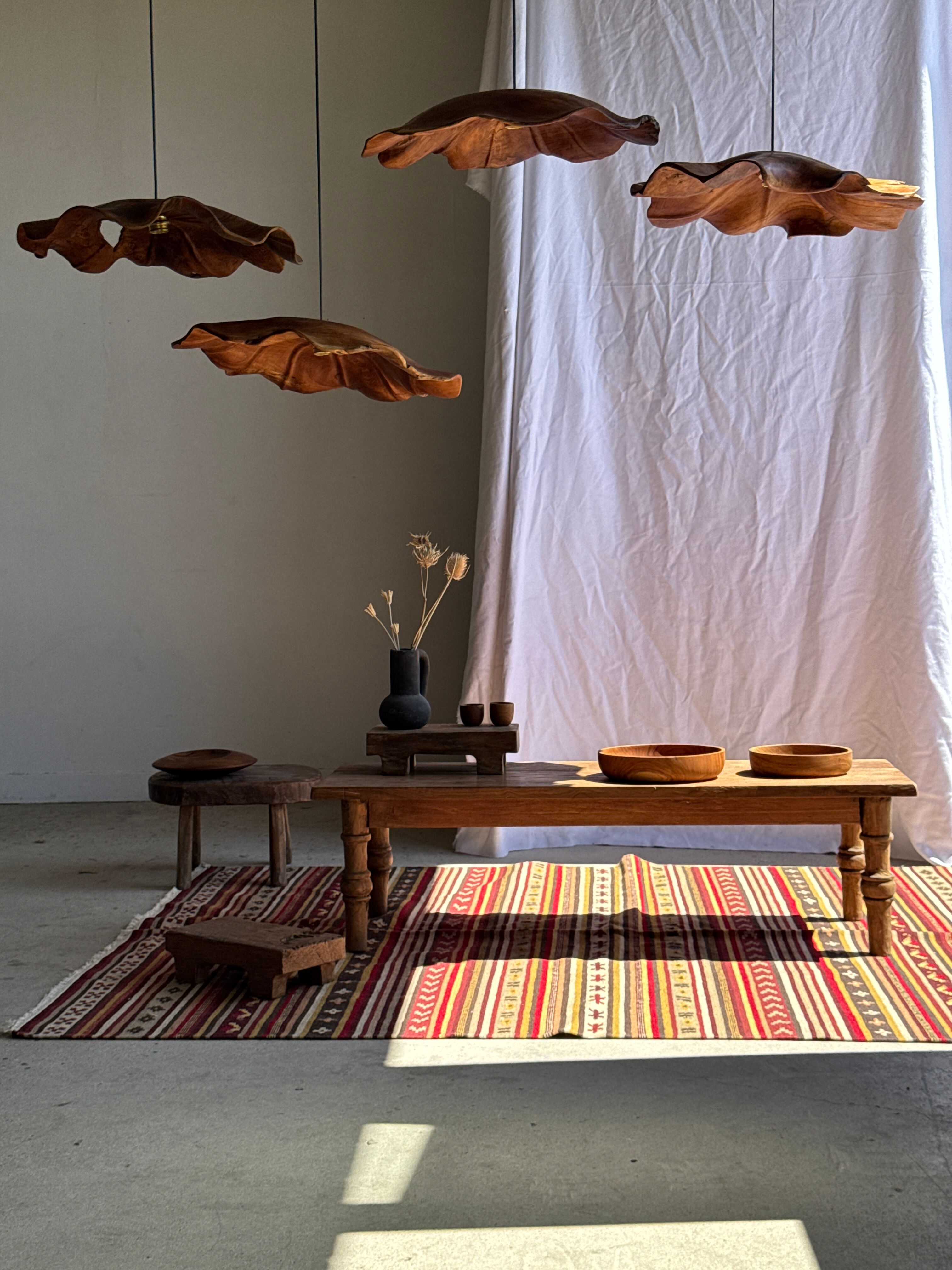 Large Indian rug with red, yellow, and white stripes and geometric fringes.