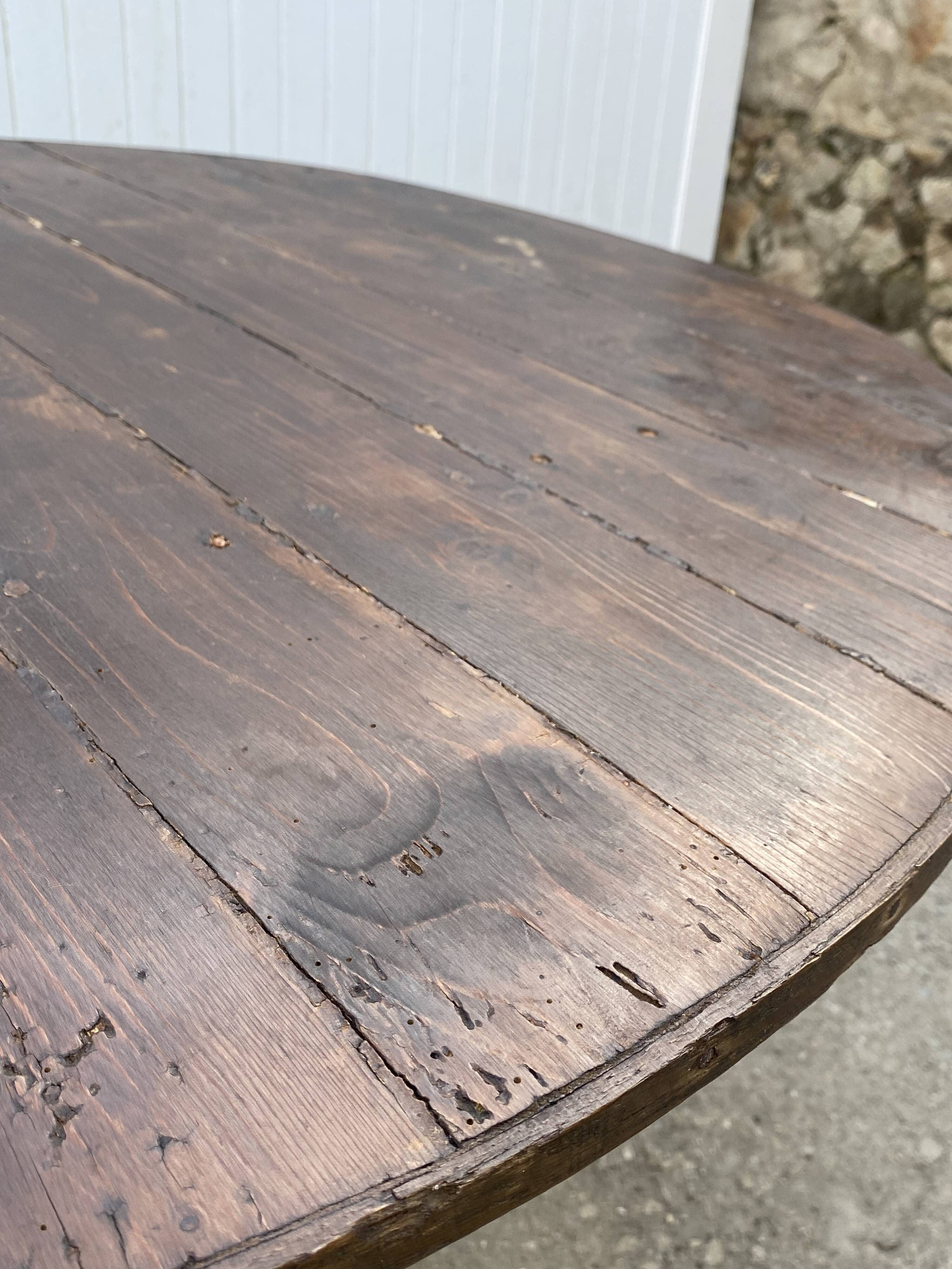 Old folding round winemaker's table with a tilting top.