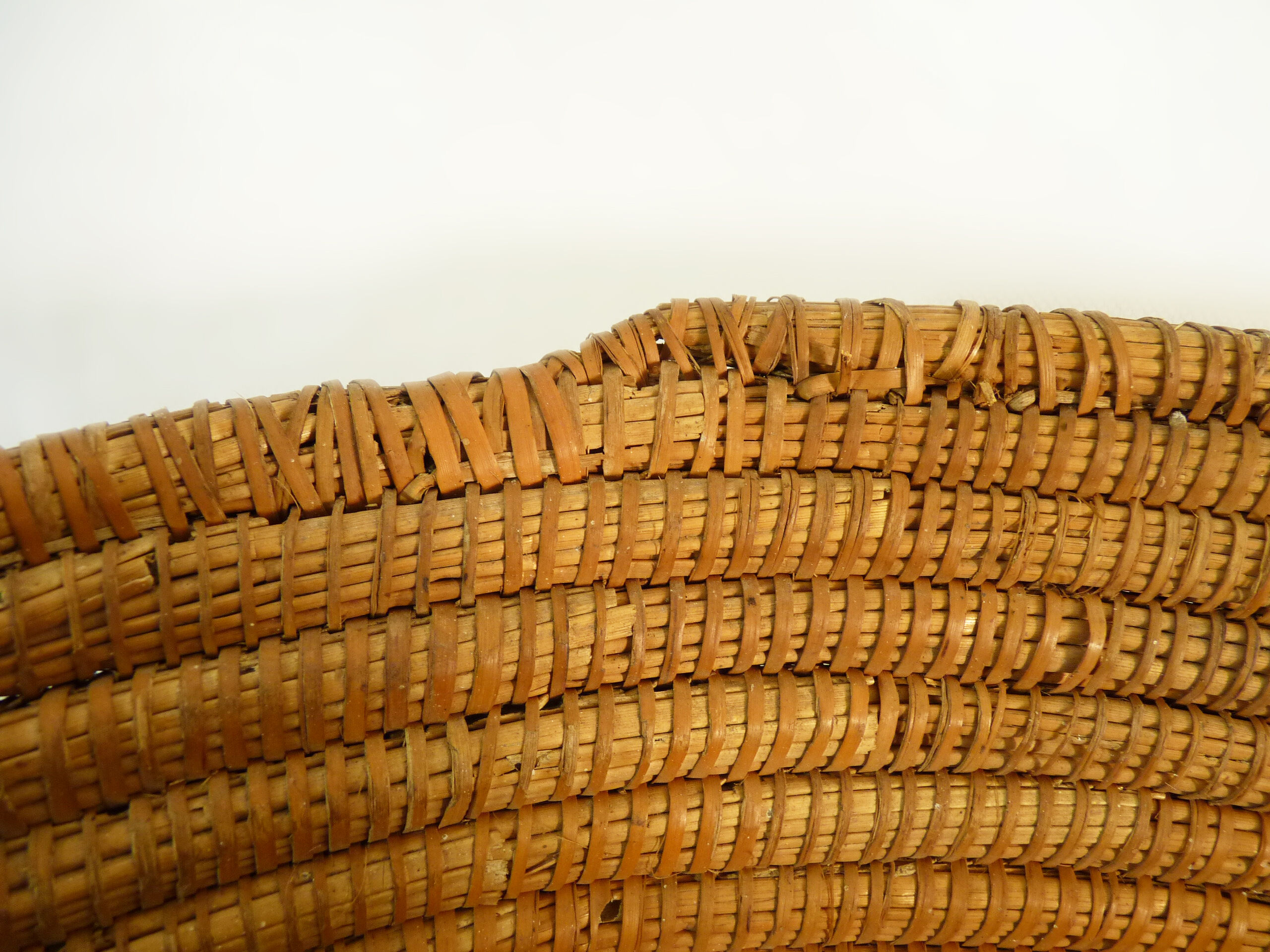 Old large bread basket of baker in braided wicker