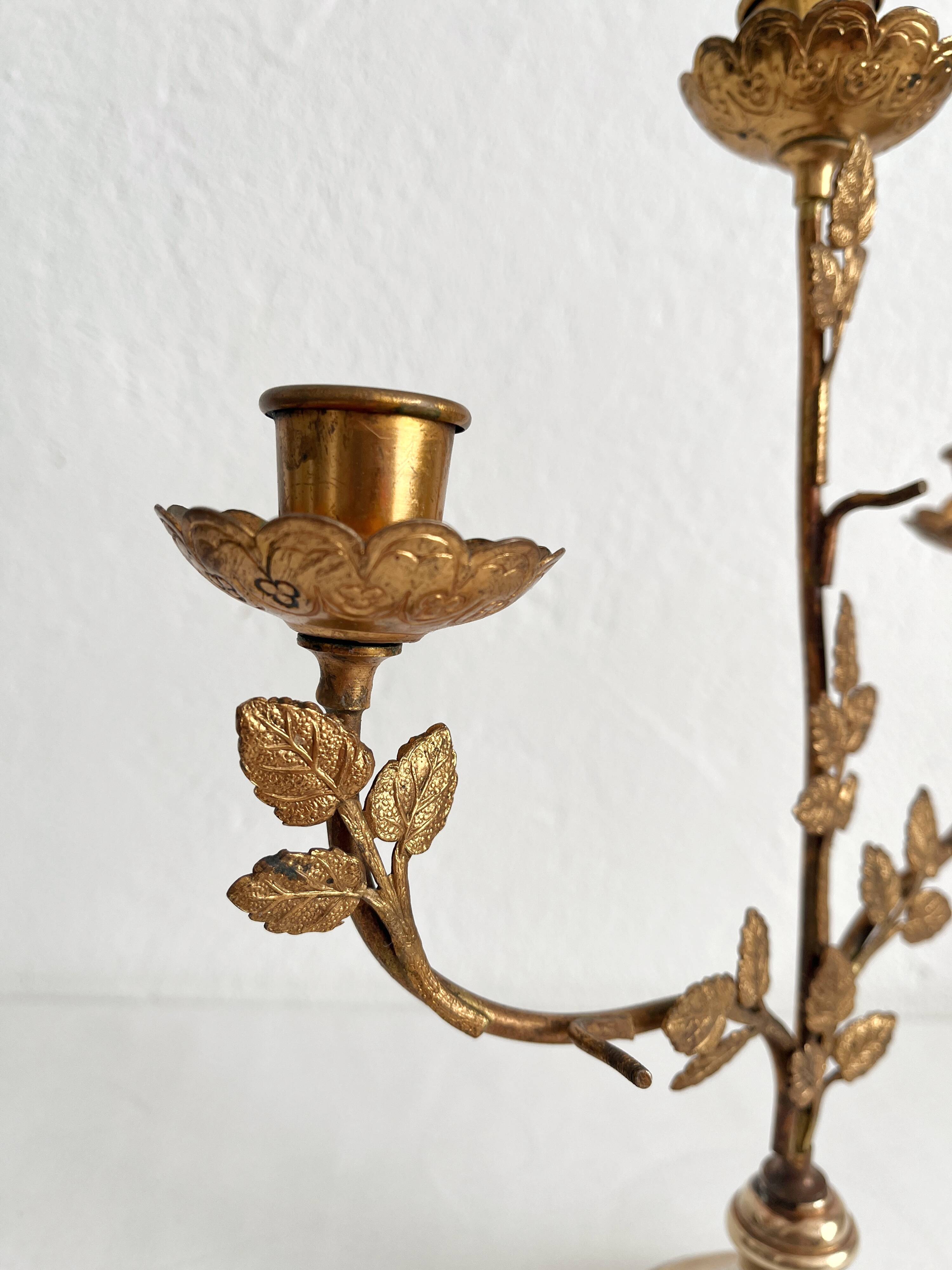 Antique bronze and brass candlestick with golden leaves