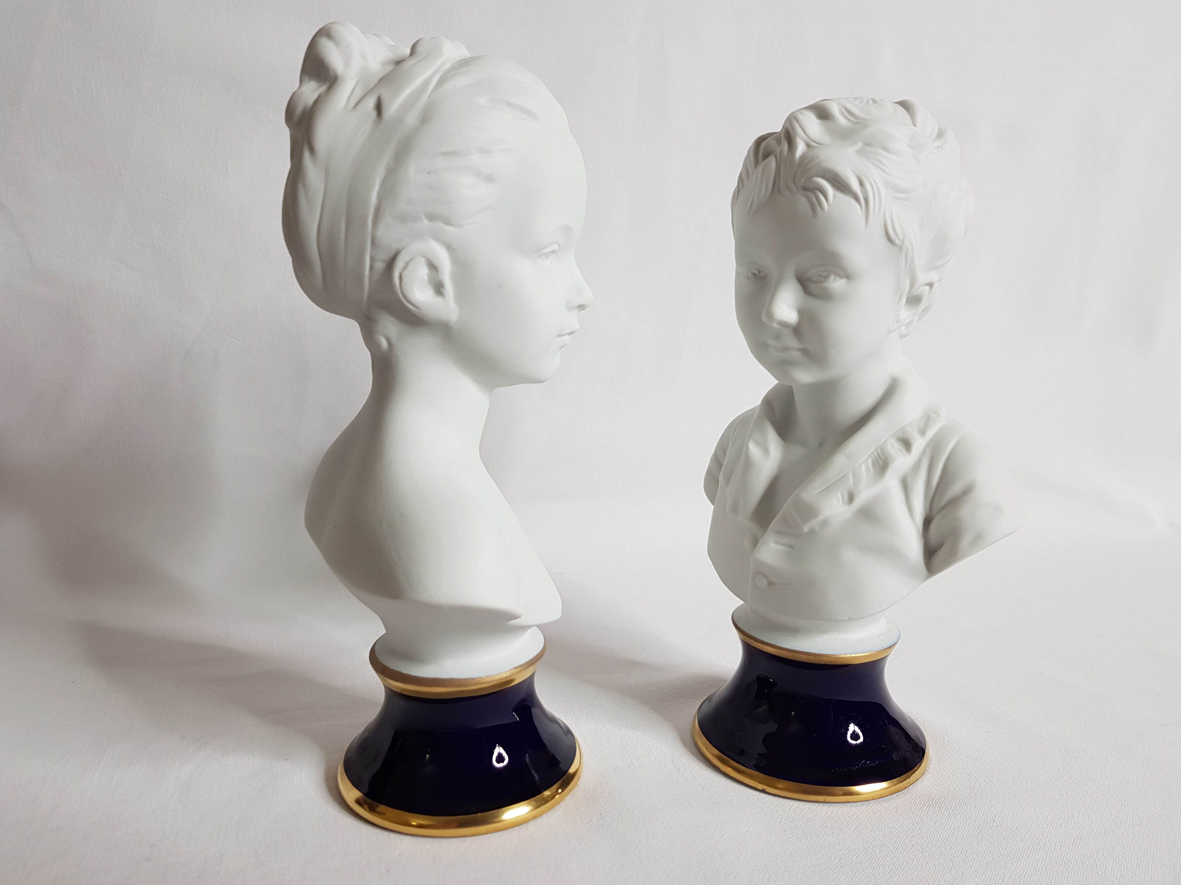Porcelain biscuit busts by Camille Tharaud, children Louise and Alexandre Brongniart after Houdon